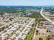 Expansive aerial view of a residential neighborhood showcasing numerous single-Gathering homes and proximity to the ocean at 657 Foxwood Blvd, Englewood, FL 34223