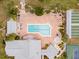 Aerial view of a community swimming pool with ample seating and nearby tennis and shuffleboard courts at 657 Foxwood Blvd, Englewood, FL 34223