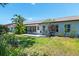 Lush backyard featuring a patio, mature trees, and beautiful landscaping at 657 Foxwood Blvd, Englewood, FL 34223