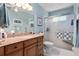 Bathroom featuring granite counters, a large mirror, and a glass shower at 657 Foxwood Blvd, Englewood, FL 34223