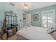Cozy bedroom with a ceiling fan, storage and a large window that provides great natural light at 657 Foxwood Blvd, Englewood, FL 34223