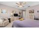 Spacious bedroom featuring a ceiling fan, dresser, and ample closet space at 657 Foxwood Blvd, Englewood, FL 34223