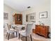 Dining room with a glass-top table, upholstered chairs, and stylish decor at 657 Foxwood Blvd, Englewood, FL 34223