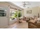 Cozy sunroom with wicker furniture and view of the private, landscaped backyard at 657 Foxwood Blvd, Englewood, FL 34223