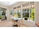 Bright Florida room featuring tile flooring and a view of the lush backyard at 657 Foxwood Blvd, Englewood, FL 34223