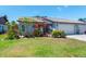 Charming home with lush landscaping, colorful flowers, and a well-maintained lawn at 657 Foxwood Blvd, Englewood, FL 34223