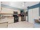 Spacious kitchen featuring stainless steel appliances and white tile floors at 657 Foxwood Blvd, Englewood, FL 34223