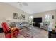 Comfortable living room with tile floors, large TV, and coordinated furniture at 657 Foxwood Blvd, Englewood, FL 34223