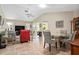 Open-concept living room with neutral tones, tile flooring, ceiling fan and comfortable furniture at 657 Foxwood Blvd, Englewood, FL 34223