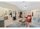 Cozy living room featuring tile flooring, a ceiling fan, and an adjacent dining area at 657 Foxwood Blvd, Englewood, FL 34223