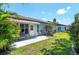 Enjoy the outdoor patio area with awning, perfect for relaxing and entertaining at 657 Foxwood Blvd, Englewood, FL 34223