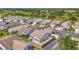 Aerial view of homes in a community with well-maintained lawns, landscaping and a golf course at 710 Ironwood Dr # 165, Venice, FL 34292