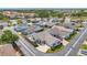 This is an aerial view of a cozy single-story home with a car in the driveway and a community pool nearby at 710 Ironwood Dr # 165, Venice, FL 34292