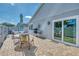 Brick paved patio with an outdoor dining set and grill for enjoying outdoor meals, and access to the sunroom at 710 Ironwood Dr # 165, Venice, FL 34292
