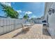 Outdoor brick-paved patio with an outdoor dining set, chairs, grill and privacy fence offers a great space at 710 Ironwood Dr # 165, Venice, FL 34292