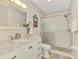 Bathroom featuring a marble vanity, decorative mirror, and glass shower at 710 Ironwood Dr # 165, Venice, FL 34292