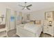 Cozy bedroom with natural light, ceiling fan, and wood floors at 710 Ironwood Dr # 165, Venice, FL 34292