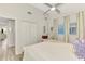 Bright bedroom featuring wood floors, white closets, and ceiling fan at 710 Ironwood Dr # 165, Venice, FL 34292