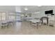 Community room with tables, chairs, and pool view at 710 Ironwood Dr # 165, Venice, FL 34292