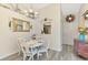 Bright dining room with table for four, vaulted ceiling, and stylish decor at 710 Ironwood Dr # 165, Venice, FL 34292