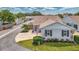 Quaint single-story home featuring a well-kept lawn and garden, an attached garage, and a welcoming entryway at 710 Ironwood Dr # 165, Venice, FL 34292