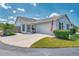 Charming single-story home with a well-manicured lawn, an attached garage, and a lovely screened-in porch at 710 Ironwood Dr # 165, Venice, FL 34292