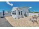 Exterior of the home featuring a brick paved patio with grill, seating and a white privacy fence at 710 Ironwood Dr # 165, Venice, FL 34292