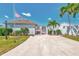 Front exterior of the property featuring tropical landscaping, an American flag, and a walkway at 710 Ironwood Dr # 165, Venice, FL 34292