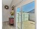 Foyer with decorative table, and sliding glass doors opening to a private patio at 710 Ironwood Dr # 165, Venice, FL 34292