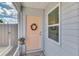 Inviting front door with a wreath, potted plant, and neutral exterior at 710 Ironwood Dr # 165, Venice, FL 34292