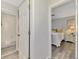 Hallway view of a bathroom and bedroom with wood floors at 710 Ironwood Dr # 165, Venice, FL 34292