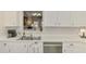 Bright kitchen featuring stainless steel appliances and white cabinetry, offering a clean and modern feel at 710 Ironwood Dr # 165, Venice, FL 34292