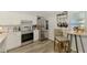Well-lit kitchen with stainless steel appliances, wood-look floors, and breakfast nook at 710 Ironwood Dr # 165, Venice, FL 34292