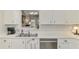 Bright kitchen featuring stainless steel appliances and white cabinetry, offering a clean and modern feel at 710 Ironwood Dr # 165, Venice, FL 34292