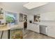 Open kitchen area with stainless steel appliances, a breakfast bar, and a window at 710 Ironwood Dr # 165, Venice, FL 34292