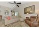 Comfortable living space featuring a sectional sofa, ceiling fan, and adjacent dining area at 710 Ironwood Dr # 165, Venice, FL 34292