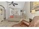 Comfortable living space featuring a sectional sofa, ceiling fan, and adjacent dining area at 710 Ironwood Dr # 165, Venice, FL 34292