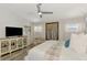 Light filled main bedroom featuring a ceiling fan, wood floors, and a decorative cabinet at 710 Ironwood Dr # 165, Venice, FL 34292