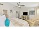 Bright main bedroom with ceiling fan, ensuite bathroom, closet, and comfortable chair at 710 Ironwood Dr # 165, Venice, FL 34292