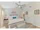 Spacious main bedroom features a ceiling fan, ensuite bathroom and hardwood style flooring at 710 Ironwood Dr # 165, Venice, FL 34292