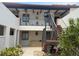 Exterior shot of a two-story building with plants and stairs at 744 Avenida Estancia # 142, Venice, FL 34292