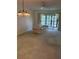Bright living room with sliding glass doors and neutral color palette at 744 Avenida Estancia # 142, Venice, FL 34292