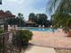Community pool with palm trees and lounge chairs under a sunny sky at 744 Avenida Estancia # 142, Venice, FL 34292