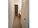 Hallway view to bathroom with vanity and walk-in shower, offering practicality and comfort at 744 Avenida Estancia # 144, Venice, FL 34292