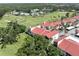 Aerial view of red-roofed condos overlooking the community golf course at 758 Village Cir # 106, Venice, FL 34292