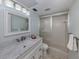 Modern bathroom with marble vanity, a sliding glass shower and updated fixtures at 758 Village Cir # 106, Venice, FL 34292