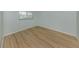 Well-lit bedroom with neutral walls, wood flooring and a window at 758 Village Cir # 106, Venice, FL 34292