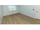 Bright bedroom featuring wood floors and a window for natural lighting at 758 Village Cir # 106, Venice, FL 34292