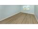 Cozy bedroom with neutral walls, wood flooring and bright window at 758 Village Cir # 106, Venice, FL 34292