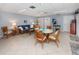 Clubhouse interior with rattan furniture, tile flooring, and ceiling fan at 758 Village Cir # 106, Venice, FL 34292